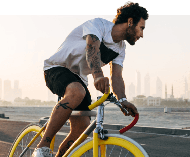 A man rides a bicycle through nature mobile