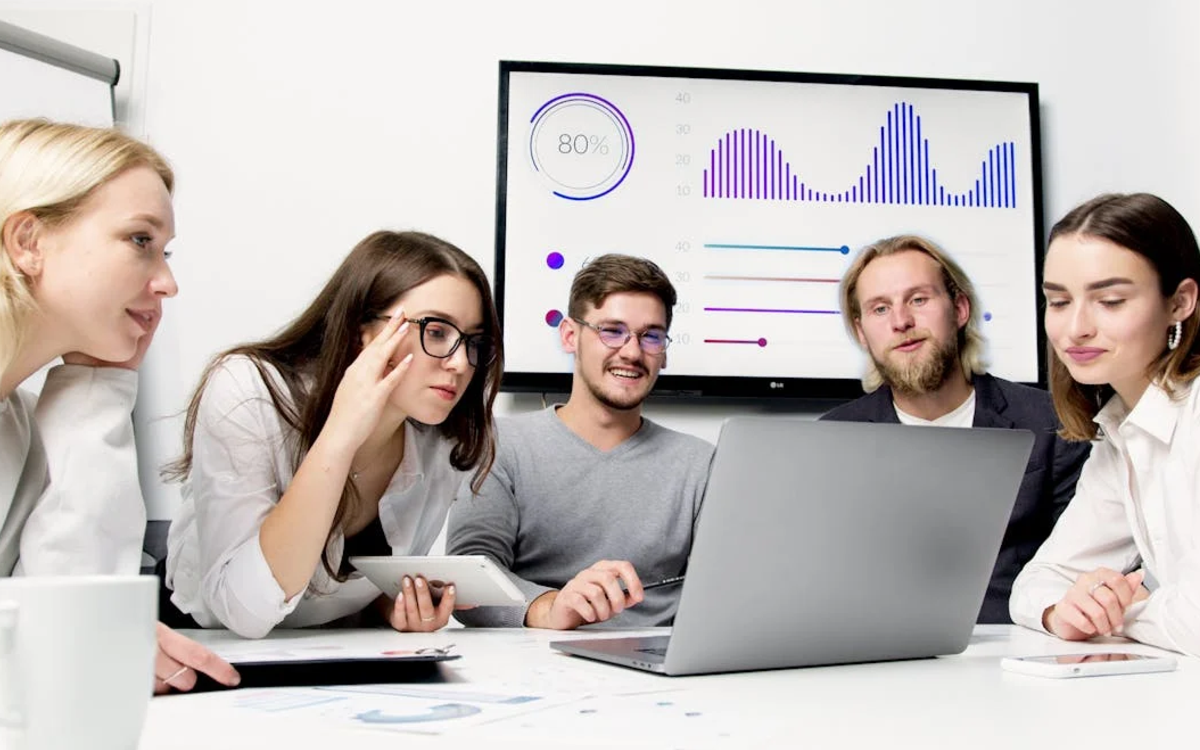 Employees sit around the computer and chat about the project